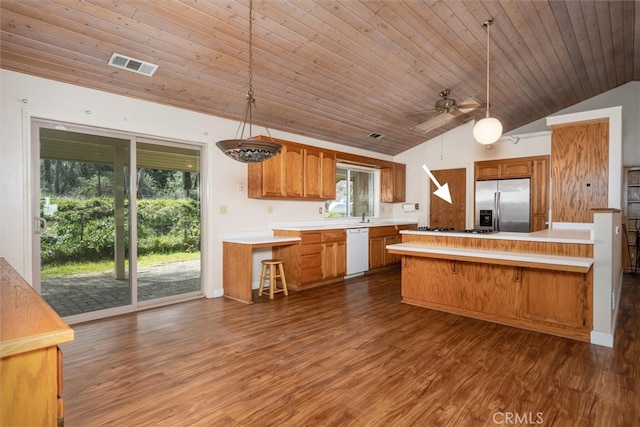51674 Rd 426, Oakhurst, CA 93644 - kitchen with light countertops, stainless steel refrigerator with ice dispenser, dark wood-style flooring, visible vents, and white dishwasher