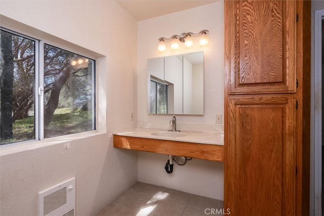 51674 Rd 426, Oakhurst, CA 93644 - bathroom with heating unit, tile patterned flooring, and a sink
