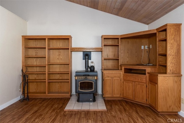 51674 Rd 426, Oakhurst, CA 93644 - living area featuring vaulted ceiling, a wood stove, dark wood-style flooring, baseboards, and wood ceiling