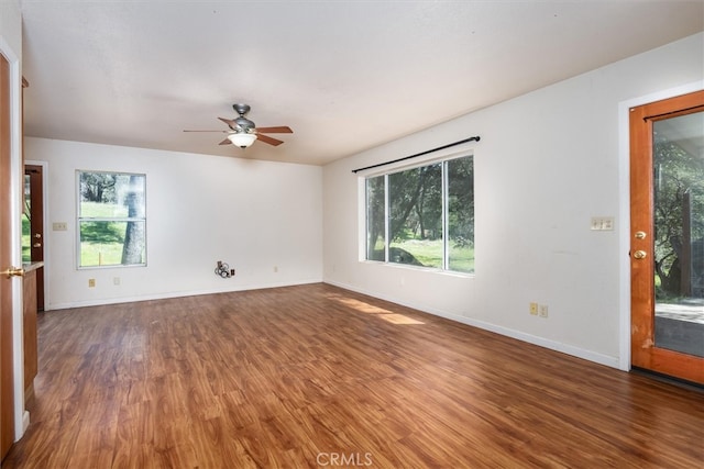 51674 Rd 426, Oakhurst, CA 93644 - empty room featuring baseboards, ceiling fan, wood finished floors, and a wealth of natural light