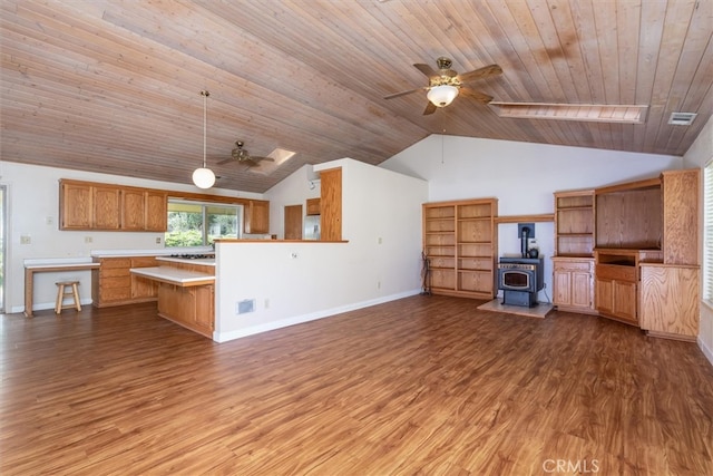 51674 Rd 426, Oakhurst, CA 93644 - kitchen with light countertops, a ceiling fan, wood finished floors, a wood stove, and visible vents