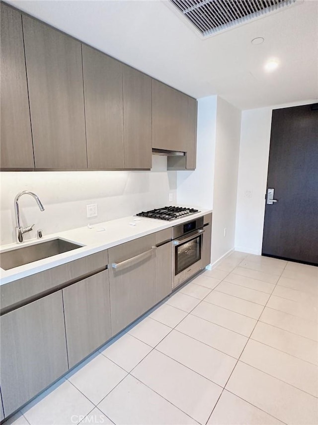 889 Francisco St Unit 2505, Los Angeles, CA 90017 - kitchen featuring appliances with stainless steel finishes, a sink, light countertops, light tile patterned flooring, and range hood