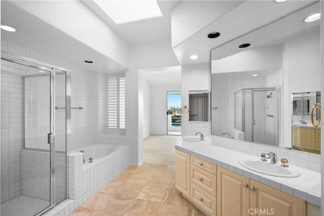 bathroom with recessed lighting, double vanity, a sink, a bath, and a stall shower