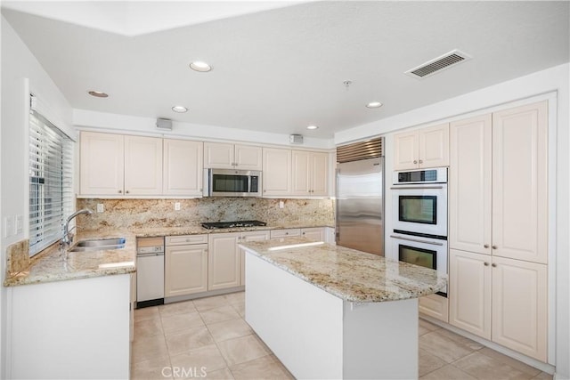 kitchen with light tile patterned flooring, visible vents, stainless steel appliances, and a sink