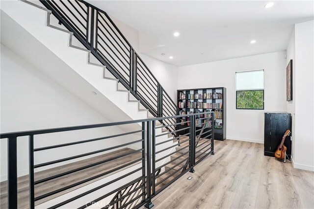 stairs featuring recessed lighting, baseboards, and wood finished floors