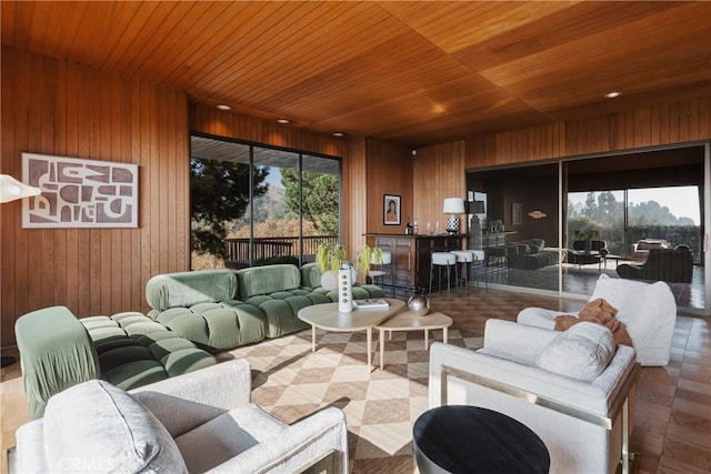 living room featuring wood ceiling and wooden walls