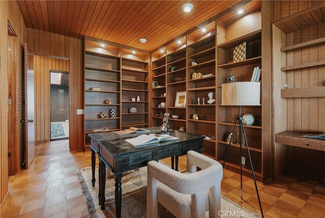 office space with built in features, wooden walls, and wood ceiling