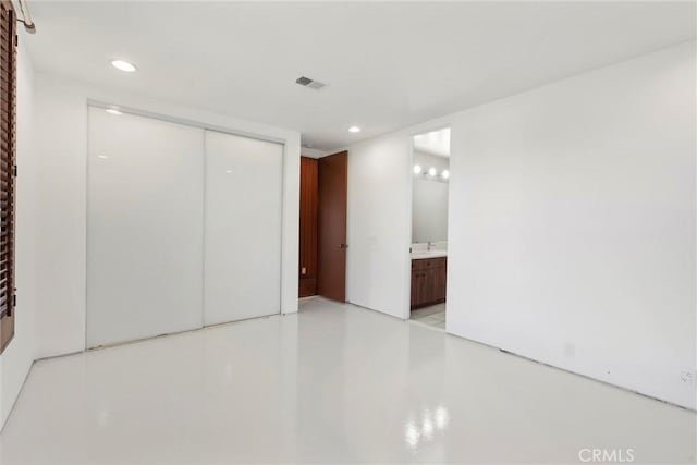 interior space with finished concrete floors, visible vents, a closet, and recessed lighting