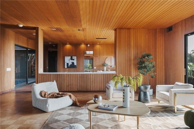 living room with wooden ceiling and wood walls