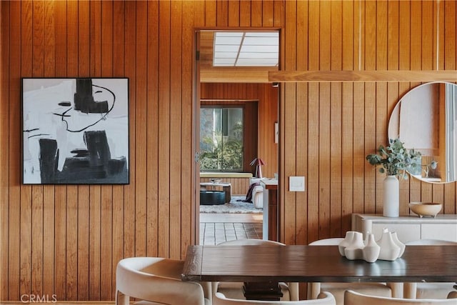 dining space with wood walls