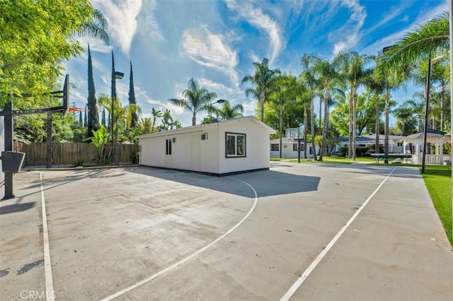 view of basketball court featuring fence and community basketball court