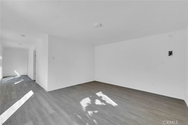 spare room with wood finished floors