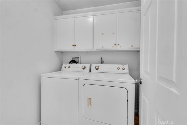washroom with cabinet space and washer and clothes dryer