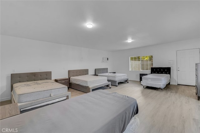 bedroom featuring baseboards and light wood-type flooring