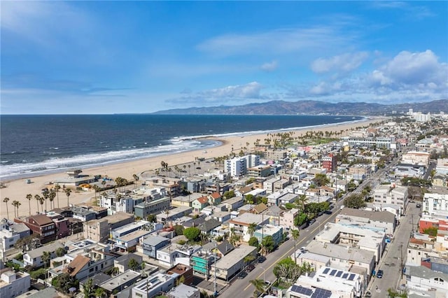 aerial view with a water view and a beach view