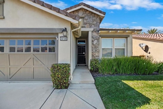 view of exterior entry with a lawn, a tiled roof, stucco siding, and stone siding