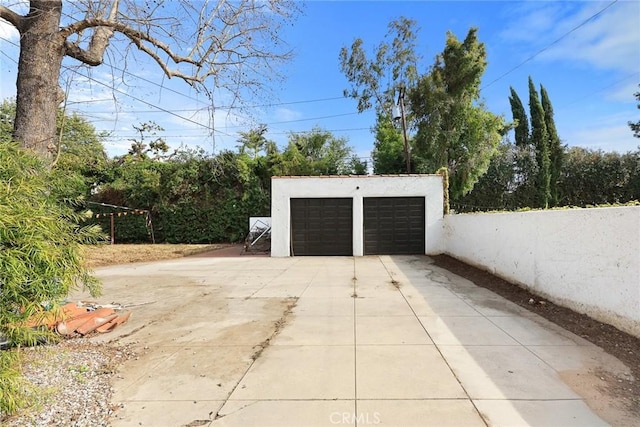 detached garage featuring fence