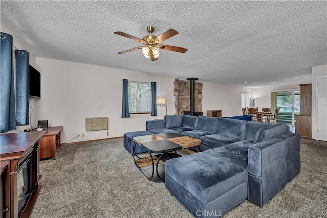 19506 Old Creek Rd, Hidden Valley Lake, CA 95467 - carpeted living area featuring a textured ceiling, a wood stove, and a ceiling fan