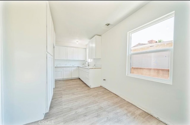 13526 Dunton Dr, Whittier, CA 90605 - kitchen with white cabinetry, light wood-style flooring, and light countertops