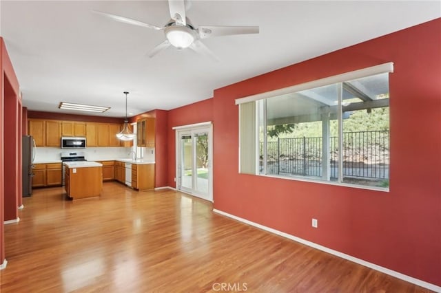 42042 Chestnut Dr, Temecula, CA 92591 - kitchen with light wood finished floors, light countertops, stainless steel appliances, and a sink