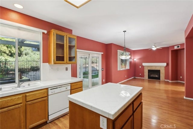 42042 Chestnut Dr, Temecula, CA 92591 - kitchen featuring tile counters, a wealth of natural light, a sink, and dishwasher