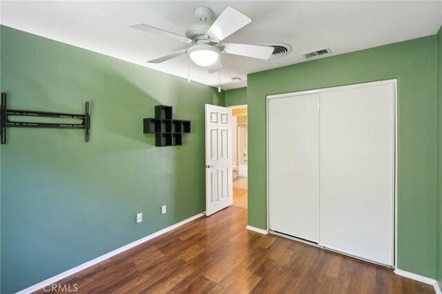 42042 Chestnut Dr, Temecula, CA 92591 - unfurnished bedroom with a ceiling fan, a closet, baseboards, visible vents, and wood finished floors