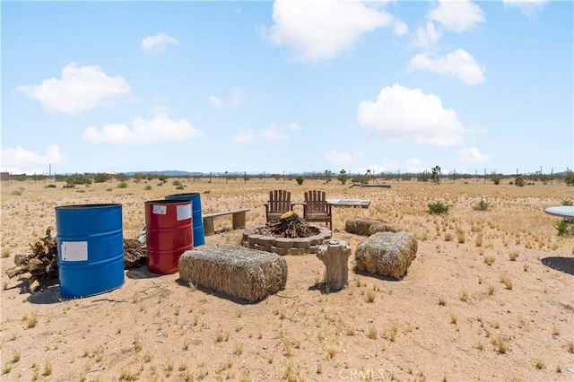 exterior space with an outdoor fire pit and a rural view