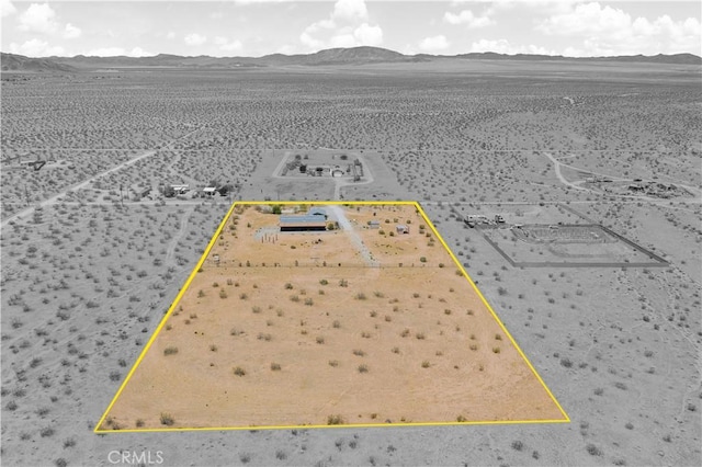 bird's eye view with a mountain view, a rural view, and view of desert