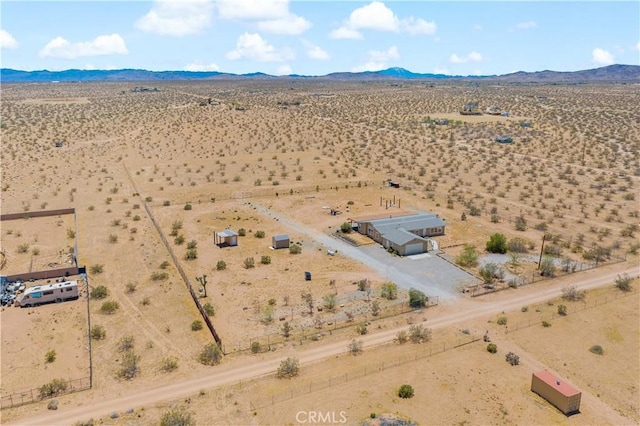 drone / aerial view with a desert view, a rural view, and a mountain view