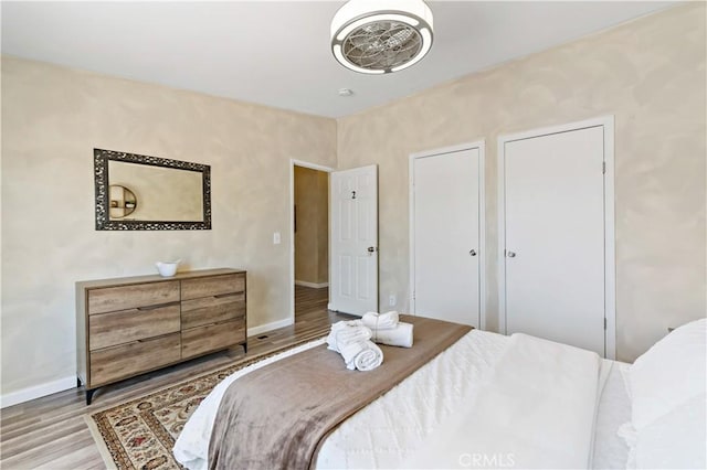 bedroom featuring baseboards and wood finished floors