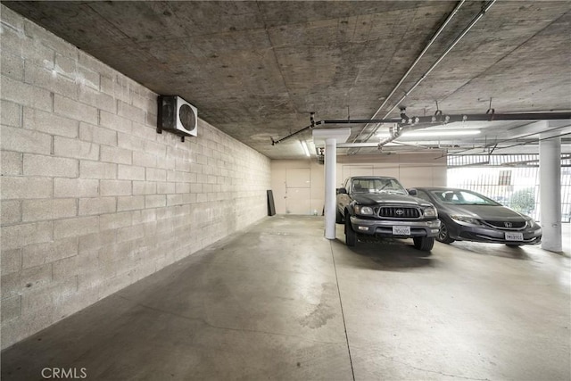 parking garage featuring concrete block wall