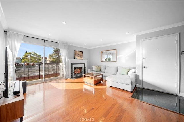 unfurnished living room with wood finished floors, recessed lighting, and crown molding