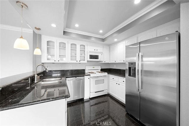 kitchen featuring a tray ceiling, recessed lighting, a sink, granite finish floor, and appliances with stainless steel finishes