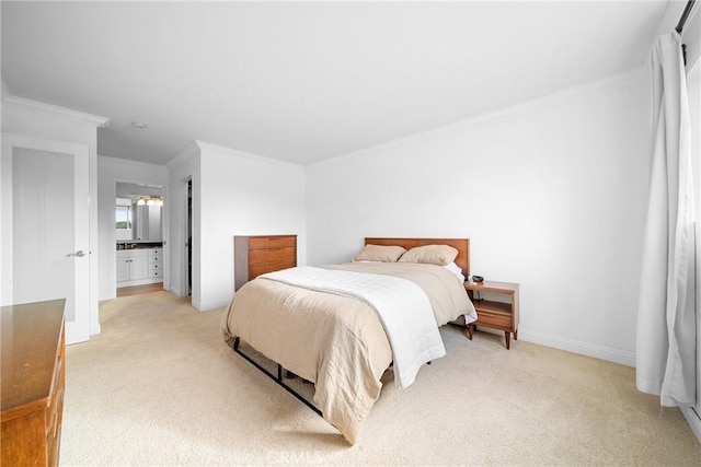 bedroom featuring baseboards, ornamental molding, ensuite bathroom, and light carpet