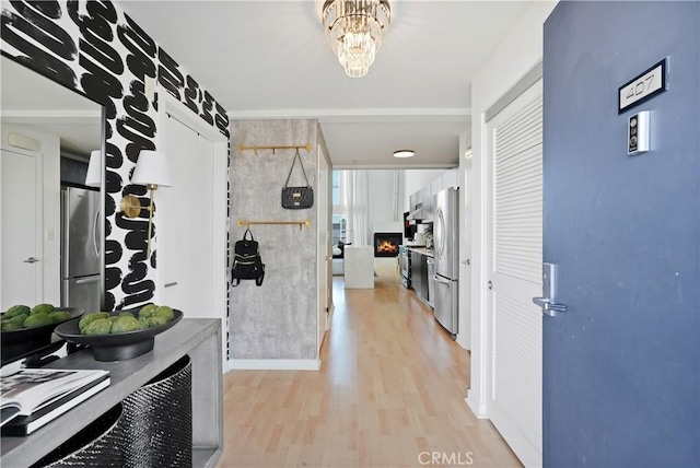 4215 Glencoe Ave Unit 407, Marina Del Rey, CA 90292 - corridor with a notable chandelier and light wood finished floors