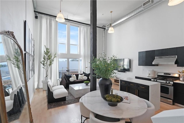 4215 Glencoe Ave Unit 407, Marina Del Rey, CA 90292 - dining area with a high ceiling, light wood-style floors, and visible vents