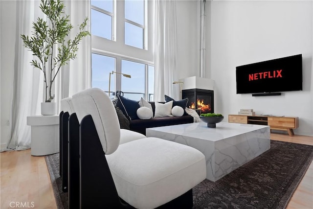 4215 Glencoe Ave Unit 407, Marina Del Rey, CA 90292 - living area featuring light wood finished floors, a fireplace, and a towering ceiling