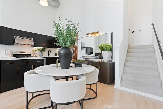 4215 Glencoe Ave Unit 407, Marina Del Rey, CA 90292 - dining space with stairs, a high ceiling, light wood-type flooring, and radiator