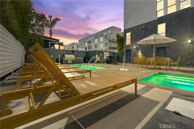 4215 Glencoe Ave Unit 407, Marina Del Rey, CA 90292 - pool at dusk featuring a fenced backyard, a community pool, and a patio