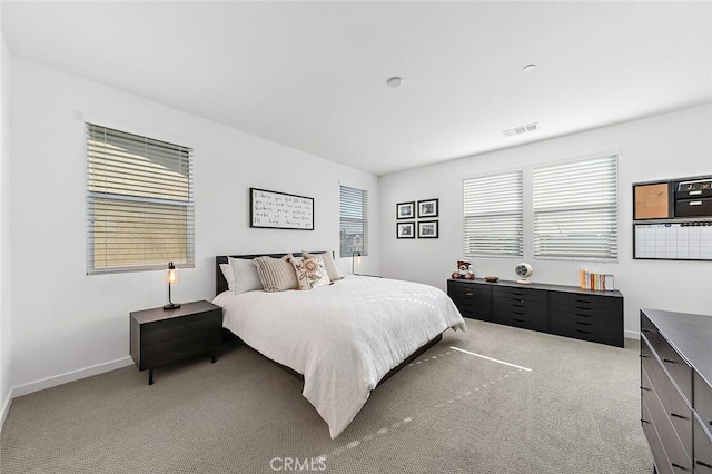 carpeted bedroom with baseboards and visible vents