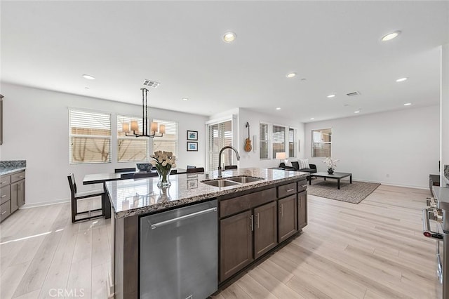 kitchen featuring dishwasher, a healthy amount of sunlight, a sink, and visible vents