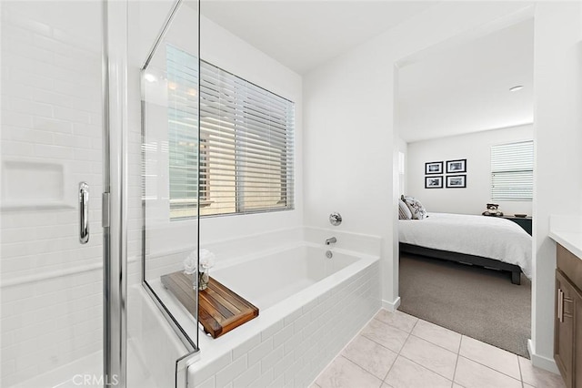 ensuite bathroom with a bath, tile patterned floors, a shower stall, vanity, and connected bathroom