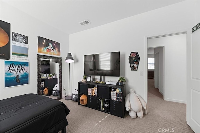 carpeted bedroom with visible vents and baseboards