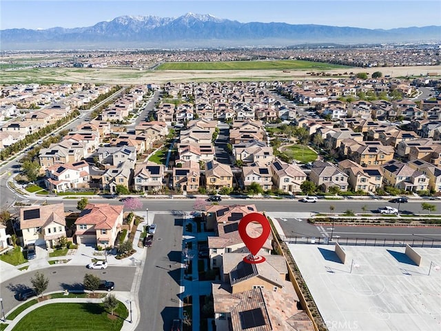 birds eye view of property with a mountain view and a residential view
