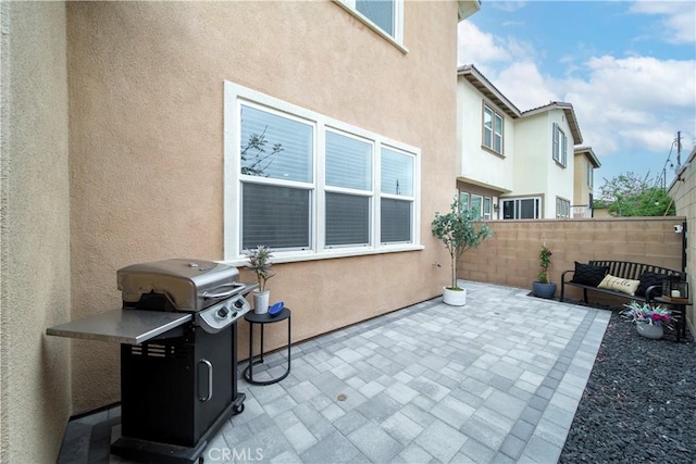 view of patio featuring fence and grilling area