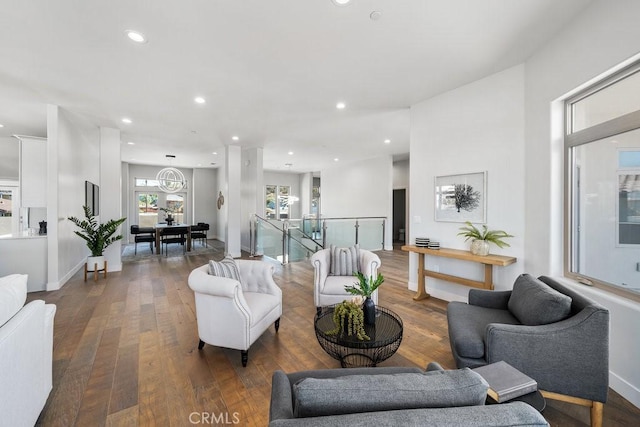 living room featuring baseboards, recessed lighting, and hardwood / wood-style floors
