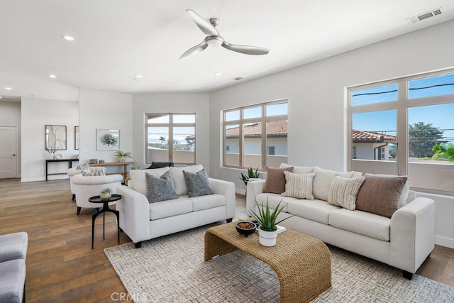 living area featuring visible vents, baseboards, ceiling fan, wood finished floors, and recessed lighting