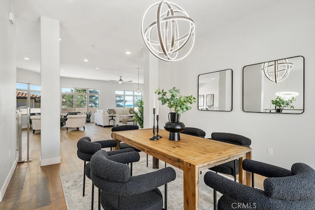 dining room with baseboards, ceiling fan, wood finished floors, and recessed lighting
