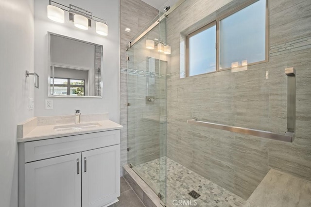 full bathroom featuring vanity and a stall shower