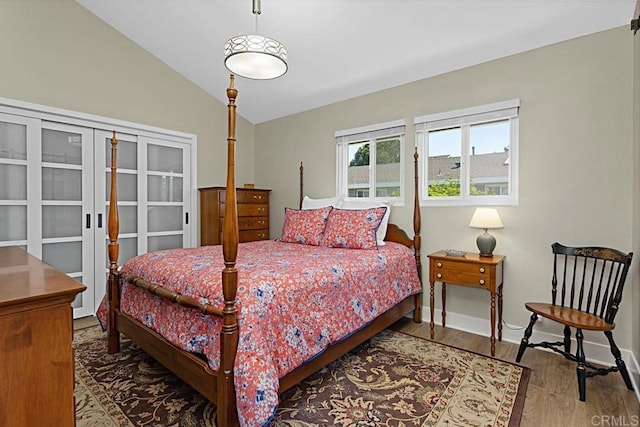 3685 Vista Campana N Unit 72, Oceanside, CA 92057 - bedroom featuring vaulted ceiling, wood finished floors, and baseboards
